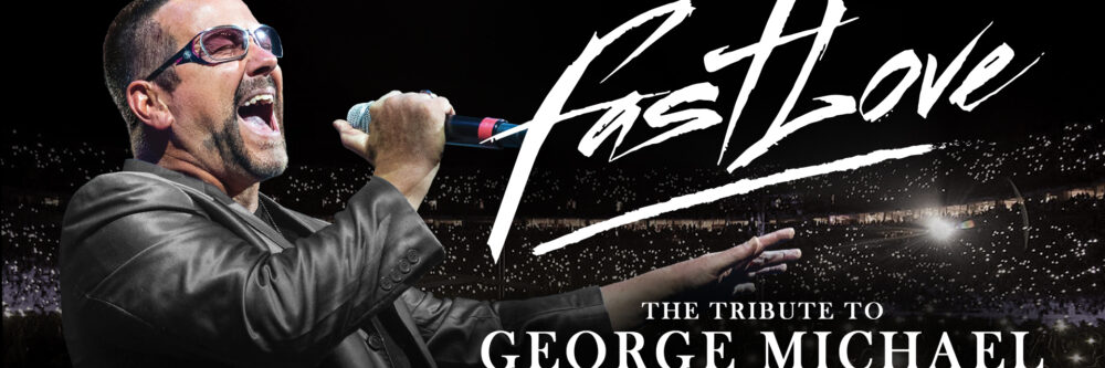 George Michael tribute artist singing into a microphone with his right hand stretching his left arm out straight, wearing a leather jacket and sunglasses